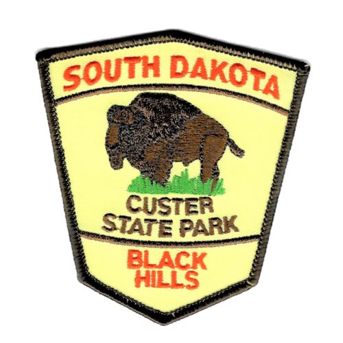Fabric patch of a yellow hexagon shield with brown trim. Text reads "Custer State Park South Dakota Black Hills" with a bison in the center.