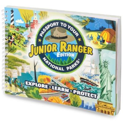 Spiral landscape-orientation book with colorful cartoons of national parks on the cover. Text reads Junior Ranger Passport