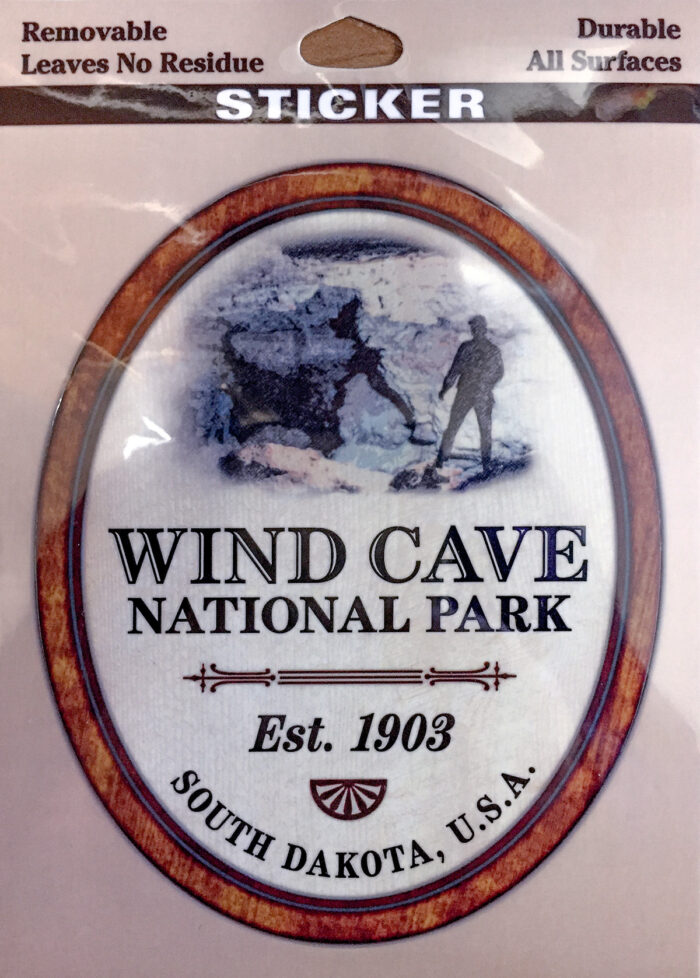 Oval sticker on a rectangular background. White with a red border. Text reads "Wind Cave National Park."