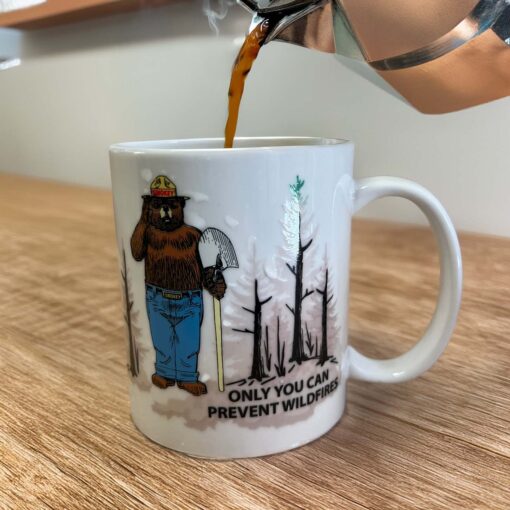 Smokey magic color changing mug with hot coffee being poured into it.