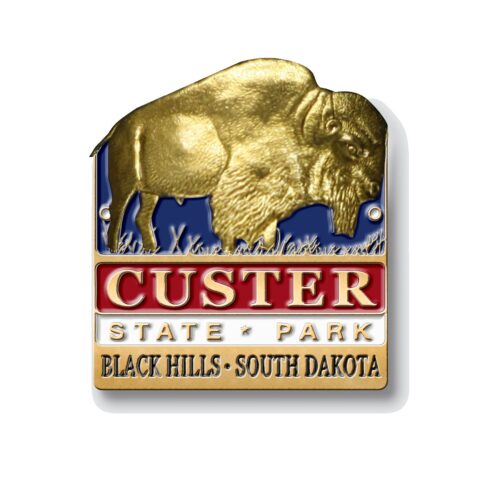 Gold, blue and red custer state park hiking medallion with image of american bison inset in gold.