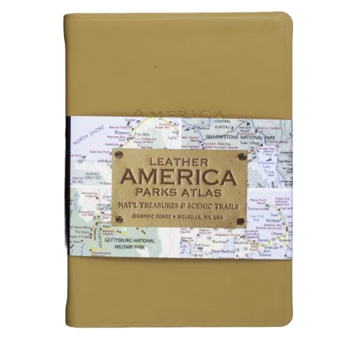 Tan leather-bound "America Parks Atlas" book with a wraparound band featuring a map background and embossed leather label.