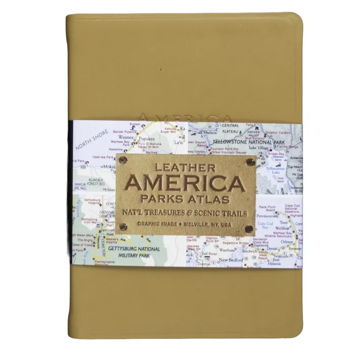 Tan leather-bound "America Parks Atlas" book with a wraparound band featuring a map background and embossed leather label.