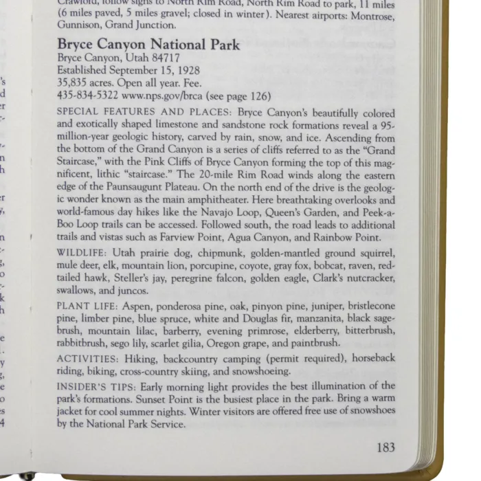 Open page from a leather-bound atlas showing a detailed description of Bryce Canyon National Park, including features, wildlife, and travel tips.