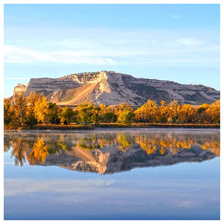 Bluffs of Scotts Bluff National Monument reflected in river water