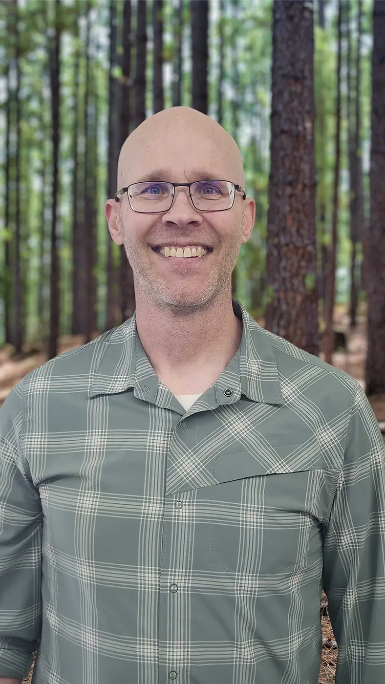 Matt Rusch Ops Mgr staff Matt Rusch, a Caucasian male with glasses and a checkerboard shirt smiling at camera