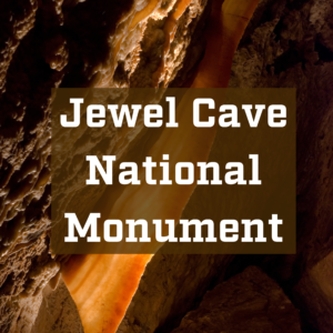 A bright cave formation called cave bacon with the text Jewel Cave National Monument