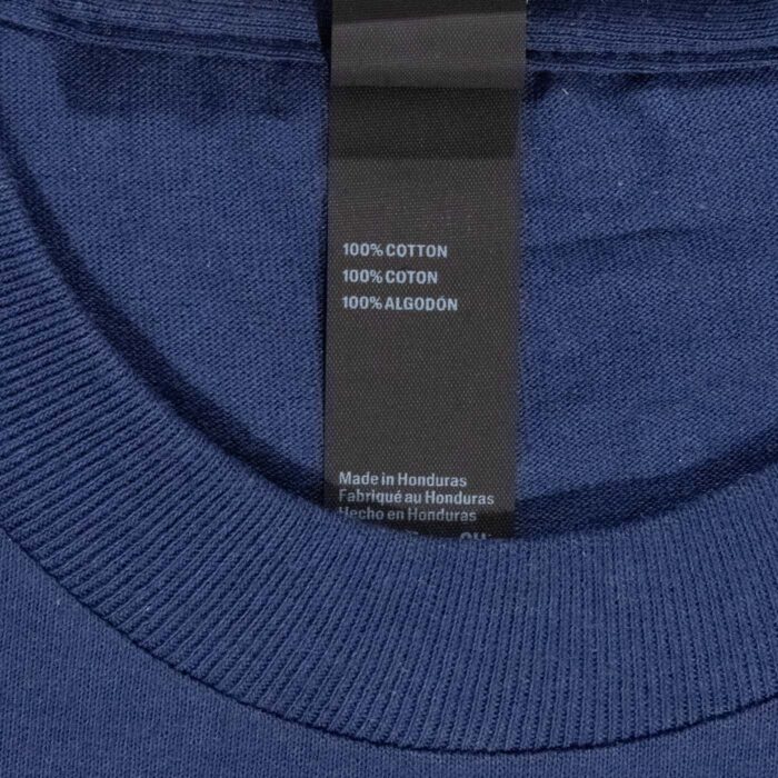 Neck label of the Wind Cave youth t-shirt showing 100 percent cotton, made in Honduras.