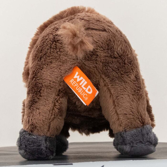 Rear view of the plush bison showing the smooth tan hindquarters, gray hooves and the orange Wild Republic brand tag
