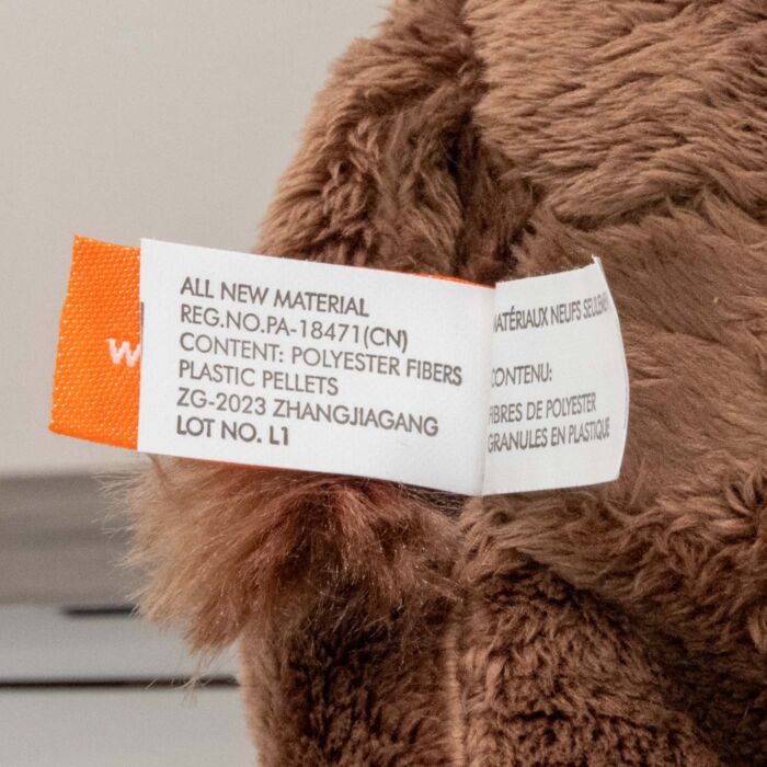Sewn law label on the plush bison reading all new material, content polyester fibers and plastic pellets