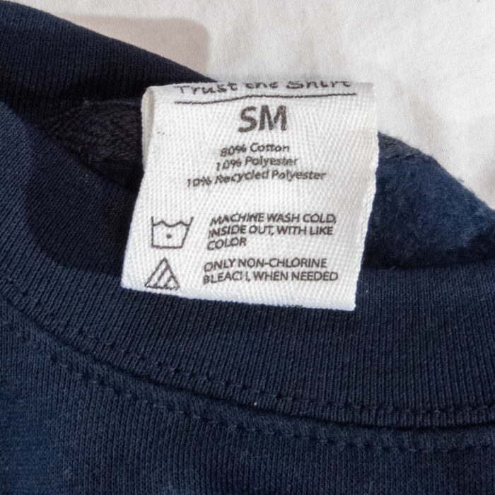 Neck label showing an 80 percent cotton fleece blend and size SM
