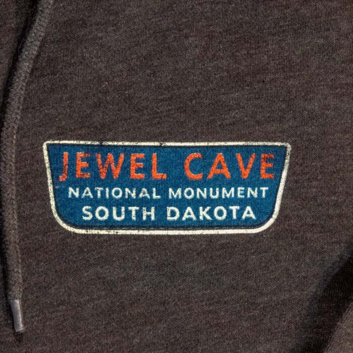 Close-up of the Jewel Cave National Monument left-chest patch, a teal sign reading Jewel Cave National Monument South Dakota