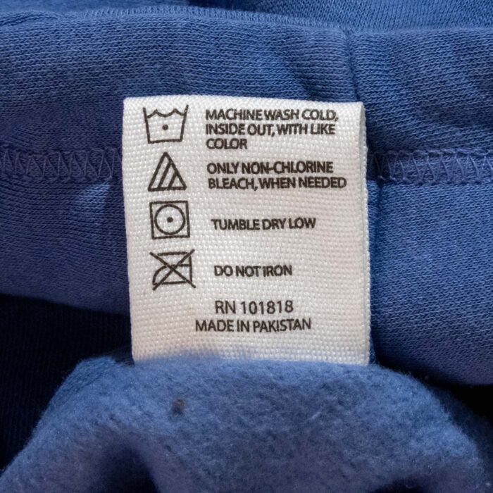 Stories in Stone hoodie care tag: machine wash cold, tumble dry low
