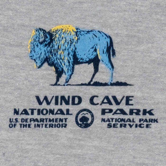 Wind Cave National Park t-shirt front graphic: blue and gold bison with park wordmark and NPS arrowhead