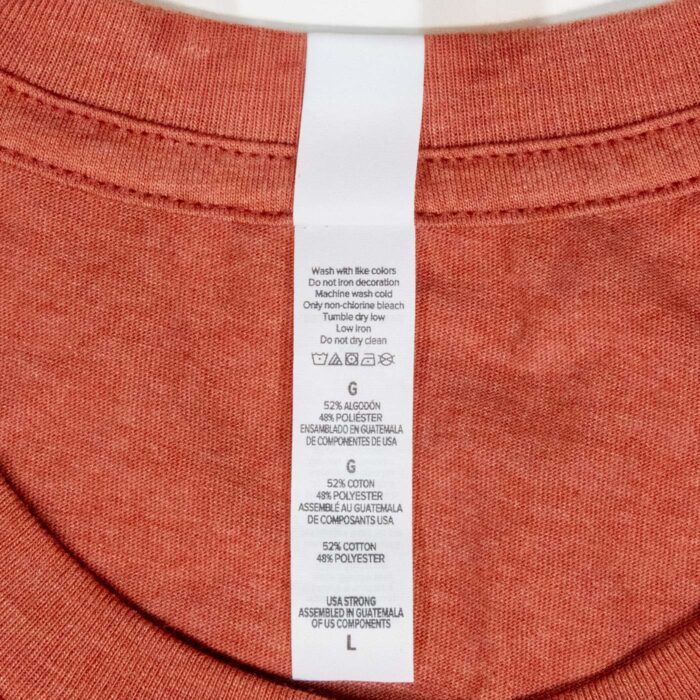Care label showing 52% cotton 48% polyester, USA Strong, assembled in Guatemala from US components