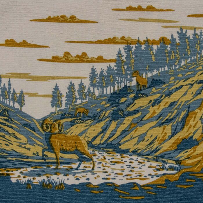 Detail of the bighorn artwork: a full-curl ram standing in a dry gravel wash below a pine ridge, with two more sheep on the slope.
