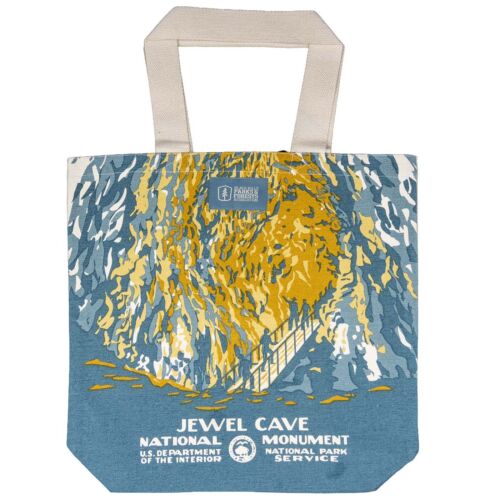 Natural canvas tote printed with a Jewel Cave chamber in gold and slate blue, a railed stairway of visitors climbing through it, with natural cotton handles.