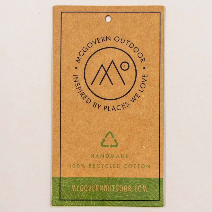 Kraft hang tag reading McGovern Outdoor, inspired by places we love, handmade, 100 percent recycled cotton.
